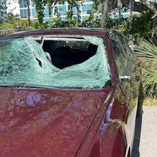 Red Chrysler 300 with a shattered windshield