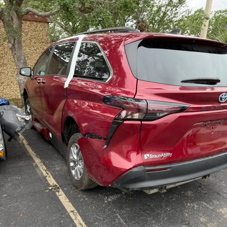 Red Toyota Sienna wheelchair van with rear quarter panel damage
